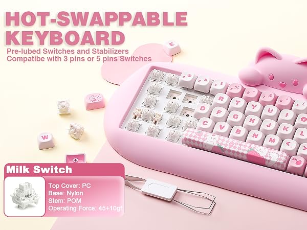 Text reads 'HOT-SWAPPABLE KEYBOARD' with subtitle text and 'Milk Switch' label. Pink mechanical keyboard with removable keycaps and white USB cable displayed on pink surface.