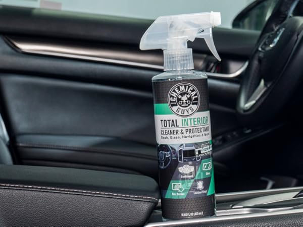 Detailer using Total Interior Cleaner on dashboard for streak-free clean