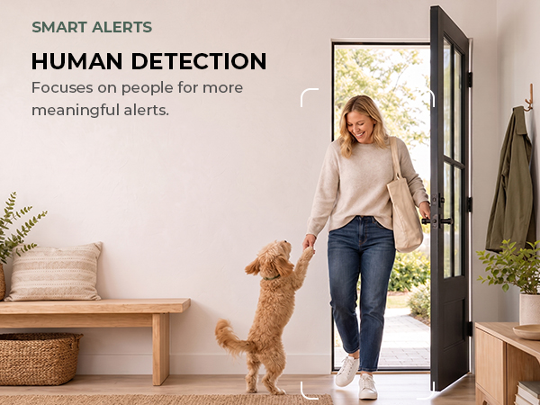 Dog at the front door as a person enters, illustrating human motion detection.