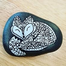 Rocks painted with opaque black and white paint pens