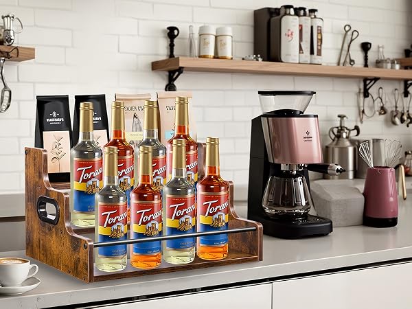 Coffee syrup bottle organizer for home cafe, tiered stand for Torani syrups and accessories.