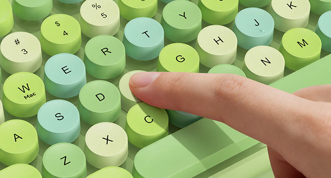 Close-up of Green Multi-Color retro keyboard round keycaps with smooth typing feel.