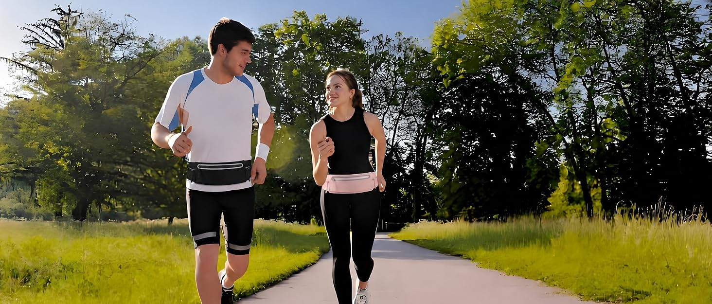 Man and woman jogging in park wearing black and pink reflective waist belt bags