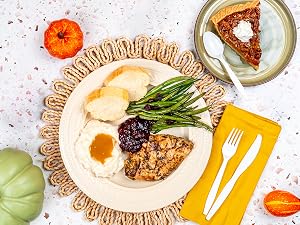 A thanksgiving dinner plate with cutlery on side.