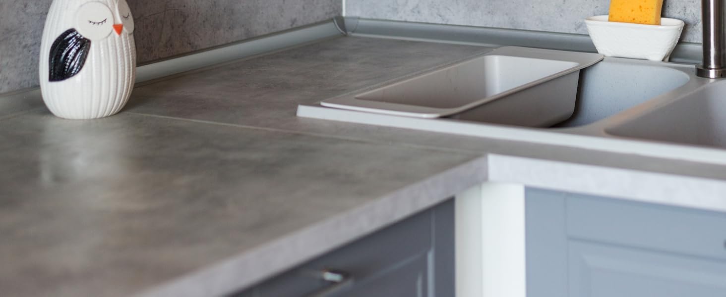 Series of images showing modern gray concrete countertops with seamless joints and clean edges in what appears to be a kitchen installation setting.