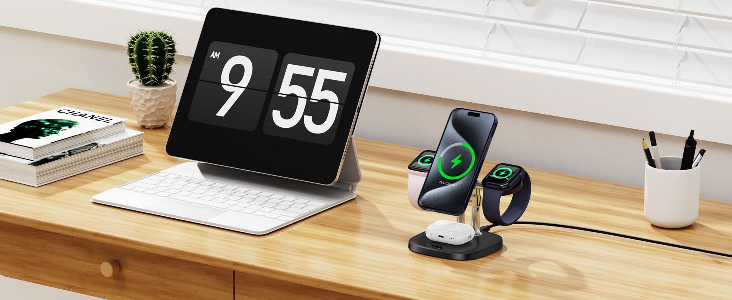 Wooden desk setup with digital clock display on tablet, smartwatch charging stand, and small cactus plant near window.