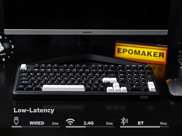 a computer monitor with a keyboard and a sign on it.