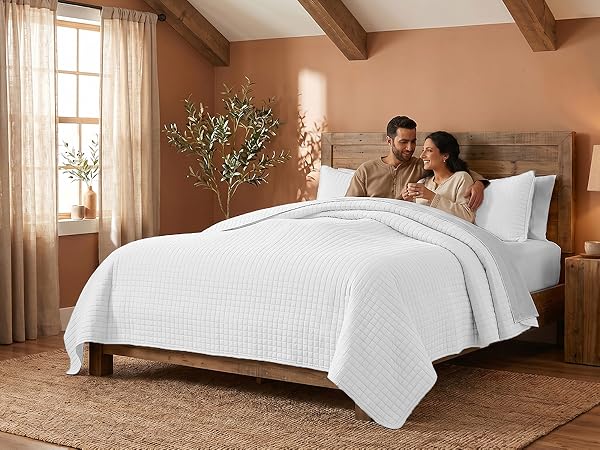 King quilt set in white with oversized dimensions and layered bedroom styling