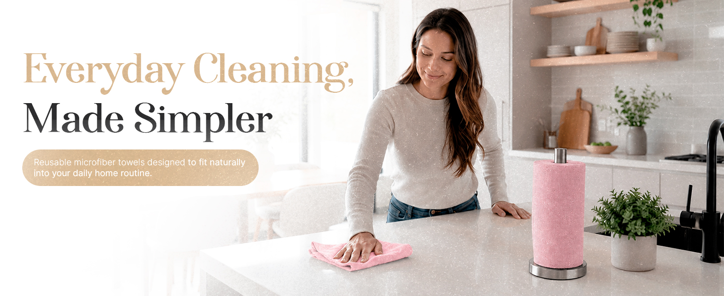 Woman cleaning kitchen counter with reusable pink microfiber towel