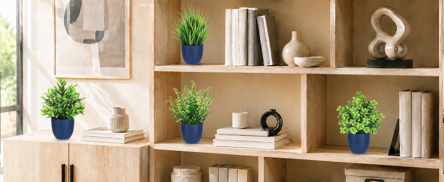 four artificial green plants blue pots bookshelf decor