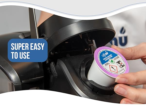 Person inserting Keurig cleaning pod into machine