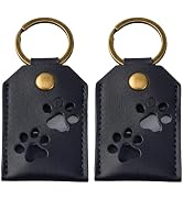 Two black leather keychains with brass rings and studs, featuring embossed paw print designs. Identical items shown side by side.