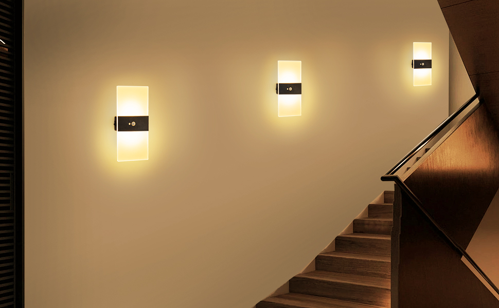 the wall lights are a modern way to light up the stairs.