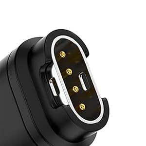 Close-up of black electronic connector with oval-shaped metal rim and four gold contact pins visible inside.