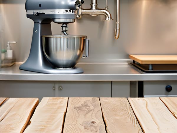 A stainless steel kitchen counter with the product and various food processing equipment.