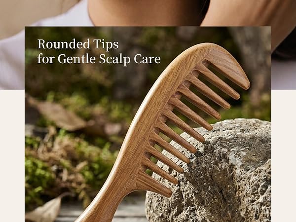 Person using a natural wooden wide-tooth comb to gently comb the scalp and hair.