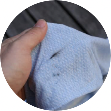 Close-up of a grease stain on a white shirt.