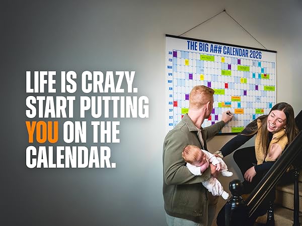 Two parents and a child on a staircase, using a giant wall calendar