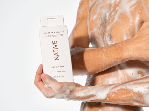 Native's coconut and vanilla sulfate-free bodywash shown in use on a man with rich creamy suds