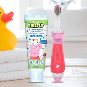 First Firefly Peppa Pig training toothbrush and toothpaste on sink
