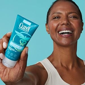 Woman holding a bottle of Curél Extreme Dry Hand Lotion