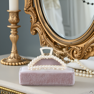 A vanity table with various hair accessories, including brushes, combs, and the product displayed pr