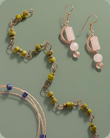 A bracelet with green beads, peach earrings, and twisted beaded wire bracelet.