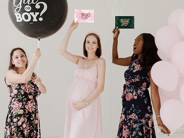 Friends celebrating with mom-to-be with variety pack thank you cards.