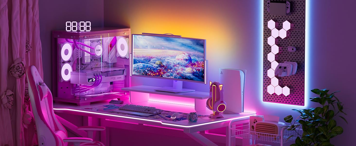 Gaming setup with purple LED ambient lighting, featuring multiple monitors and gaming peripherals arranged on a desk in a dark room.