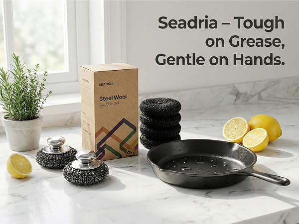 Stainless steel scrubber with metal handle on cast iron skillet for heavy duty cleaning.