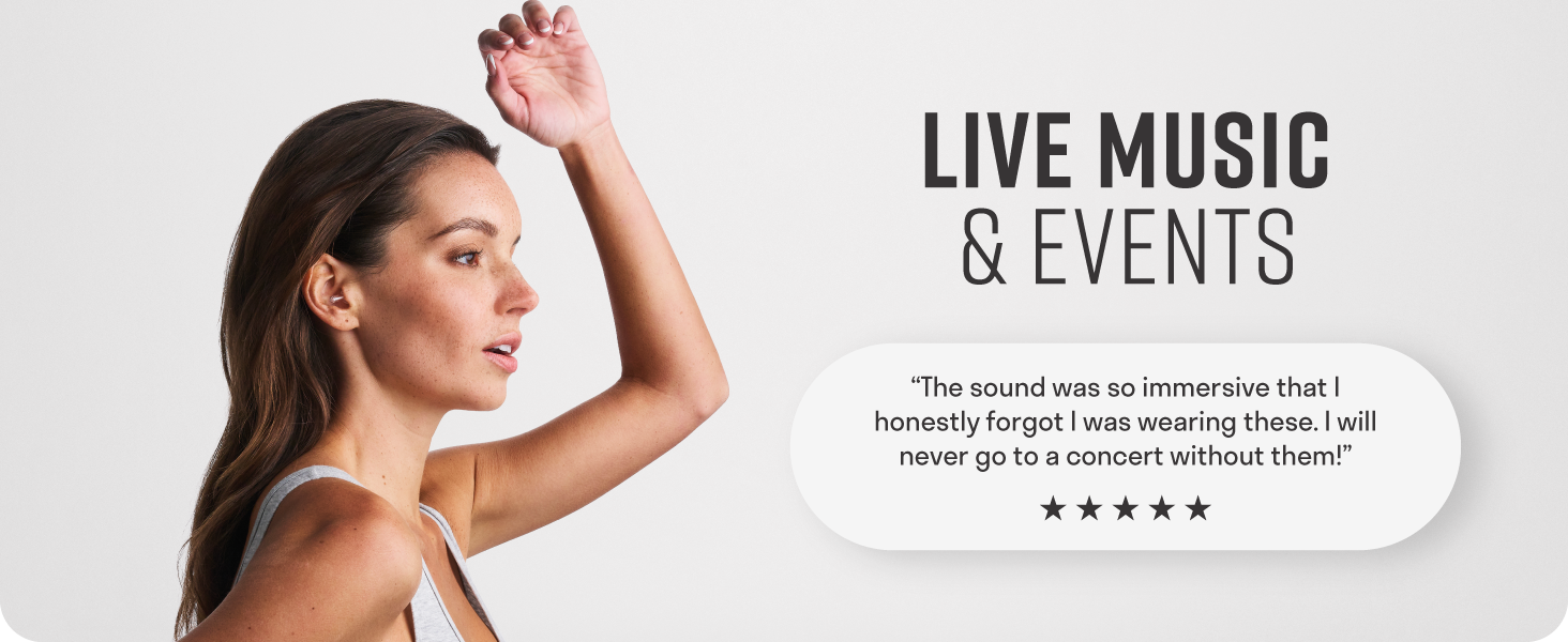 Happy woman enjoying live music while her vibes earplugs reduce decibels to protect her hearing