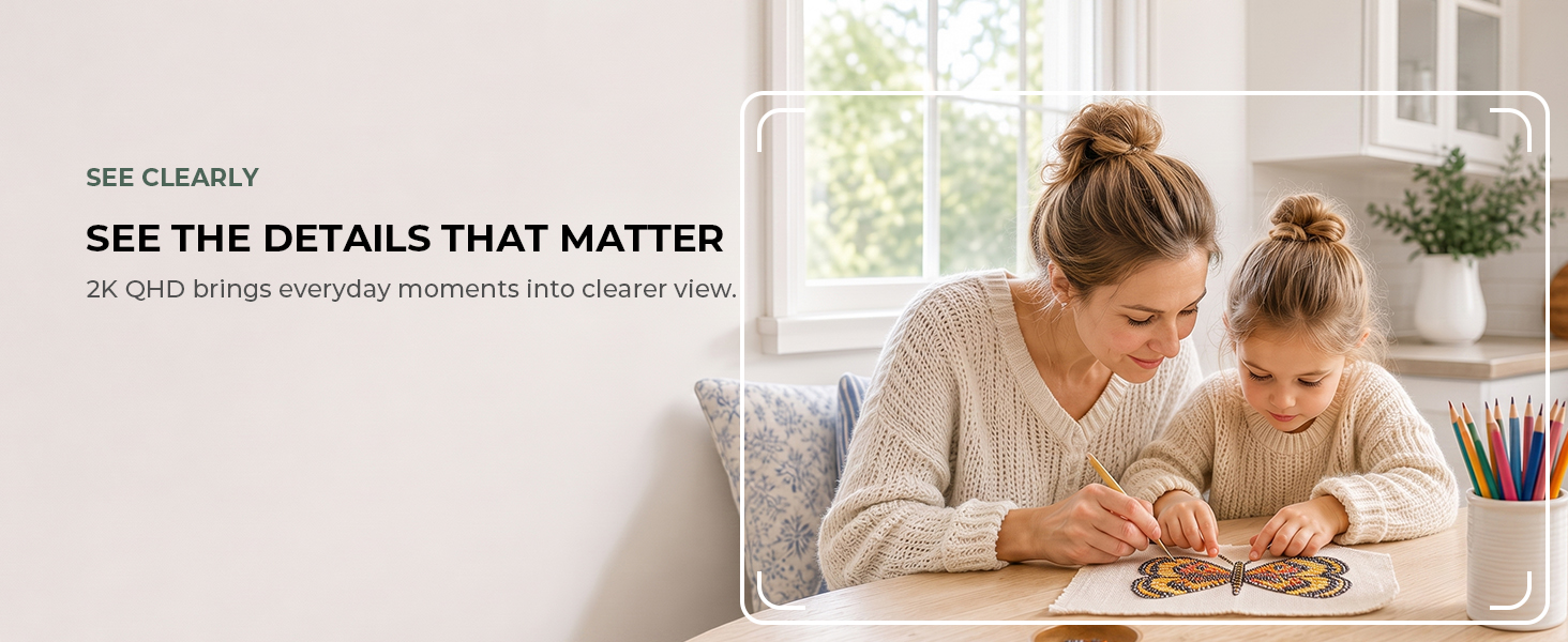 Mother and child view a tablet beside a white indoor camera in a bright home.