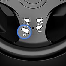 Close-up view of a black control panel with white buttons and a blue-rimmed circular display or indicator.