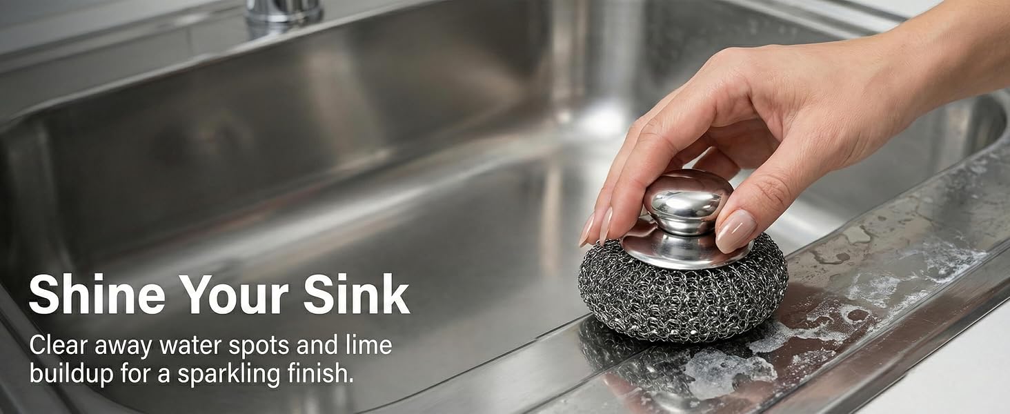 Metal sponge cleaning water spots and limescale from stainless steel kitchen sink.