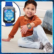 Kid shows off the watch face he has chosen.