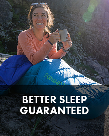 Woman drinking in a sleeping bag