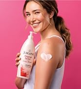 Woman holding a bottle of Jergens Original Scent with a swatch of lotion on her arm