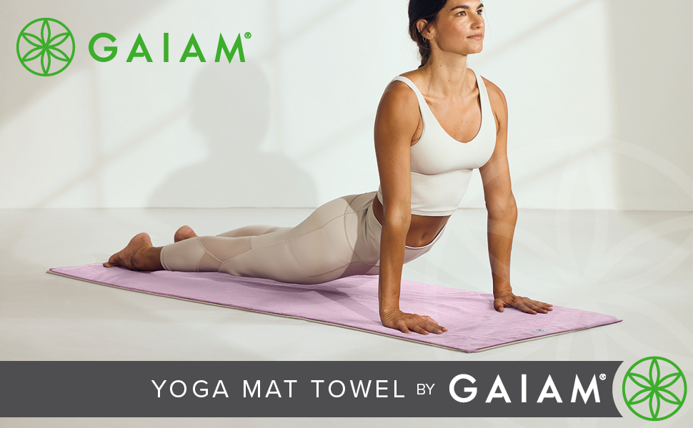 Woman practicing yoga on mat with Gaiam yoga mat towel for improved grip and stability