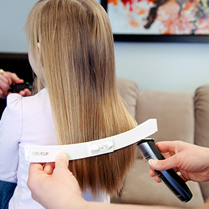Mom cutting kids hair at home using Original CreaClip hair cutting tool