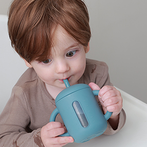 samigo baby drinking out of a straw cup blue
