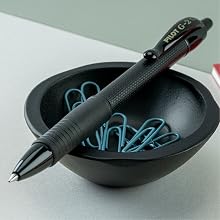 Photo shows G2 Edge pen resting on a desk's tiny bowl of paperclips