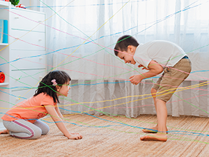 children playing with string in the room