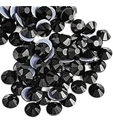 Collection of black faceted crystal or glass beads arranged in groups, showing their reflective surfaces and geometric cuts.