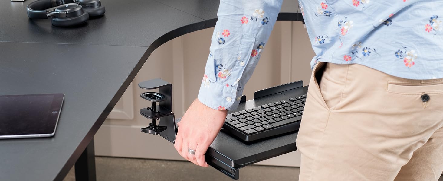 Man placing keyboard tray on desktop