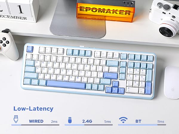 a keyboard with a blue and white keyboard on a desk.