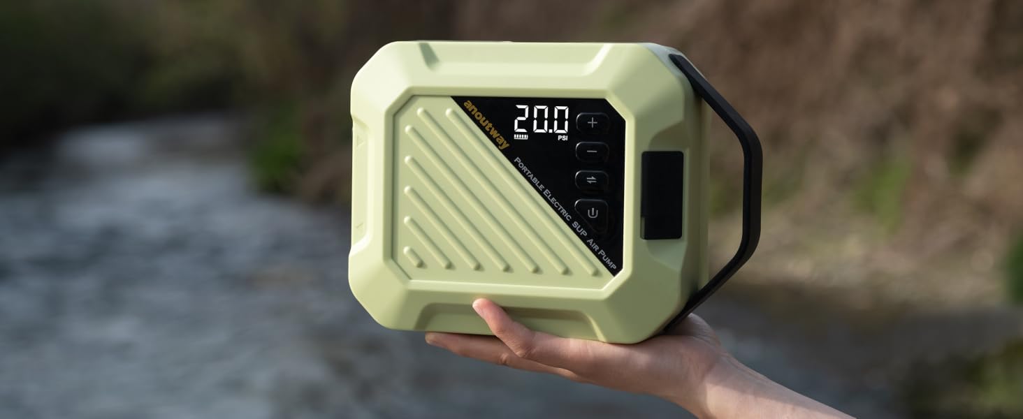 Portable electronic device with digital display showing '200'. Light green rectangular casing with diagonal ridges. Black handle. Held in hand outdoors near water.