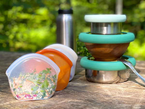 Reusable containers holding food for a picnic outdoors