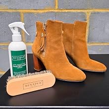 Product care demonstration showing suede boots and cleaning supplies, including a spray bottle labeled 'RENEWER' and tan or orange colored footwear.