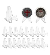 A set of clear plastic display stands in various sizes, alongside two round gauges or meters with dark faces and red indicators.