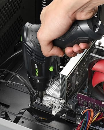 Hand using power tool to work on computer hardware. Interior of PC case visible with components including cooling fan and circuit boards.